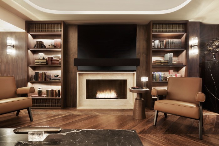 The fireplace in the basement lounge of the shop, with the Berluti armchairs that helped inspire the refurbishment