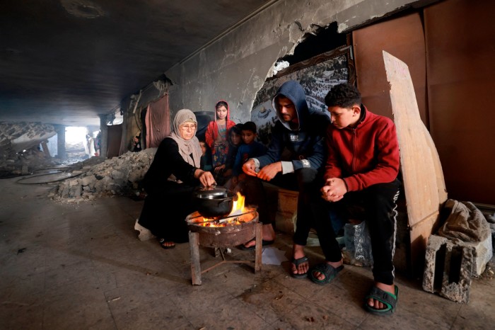 Displaced Palestinians prepare food as they shelter inside a damaged building in Rafah on Wednesday