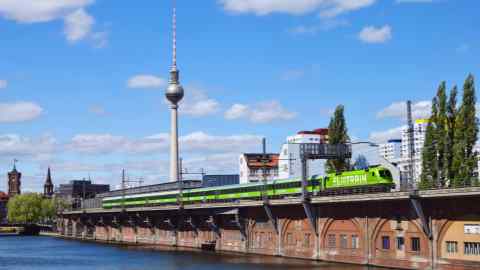 A green Flix train in Berlin