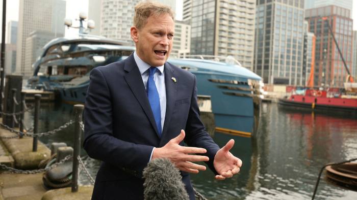 UK transport secretary Grant Shapps with the impounded Russian-owned yacht Phi in Canary Wharf, east London.