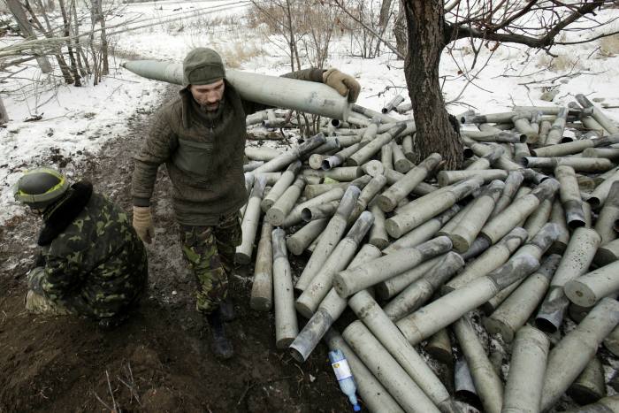 Ukrainian gunner walks past boxes of shells in the village of Pisky in Donetsk in 2014