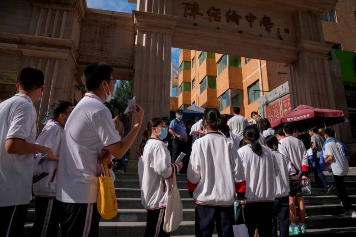 Students line up for their national college entrance examinations in Beijing in June