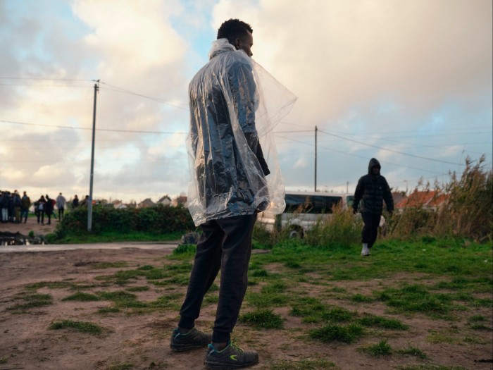 Man stands in a clear plastic rain jacket 
