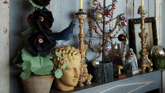 Candles, Christmas decorations and a paper hollyhock by The Green Vase at artist John Derian’s New York home