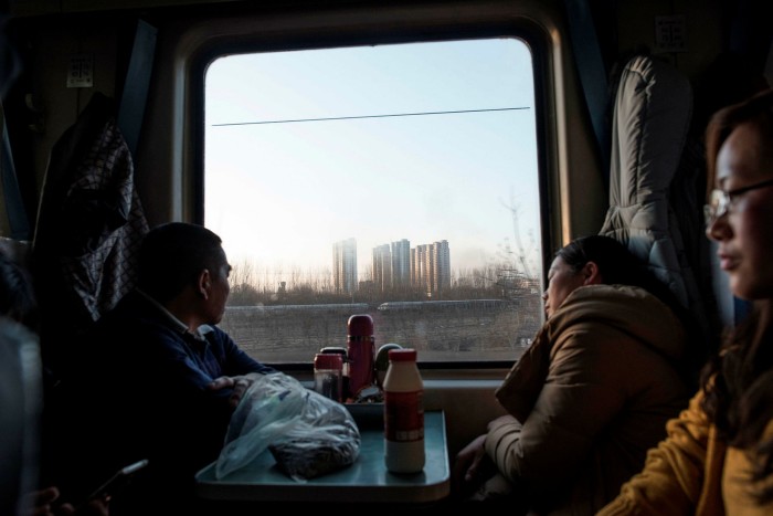 passengers sitting on a train as it leaves Beijing for the 26-hour journey to Chengdu before the new lunar year