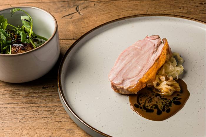 Smoked pork loin with onion choucroute and broth at Heft