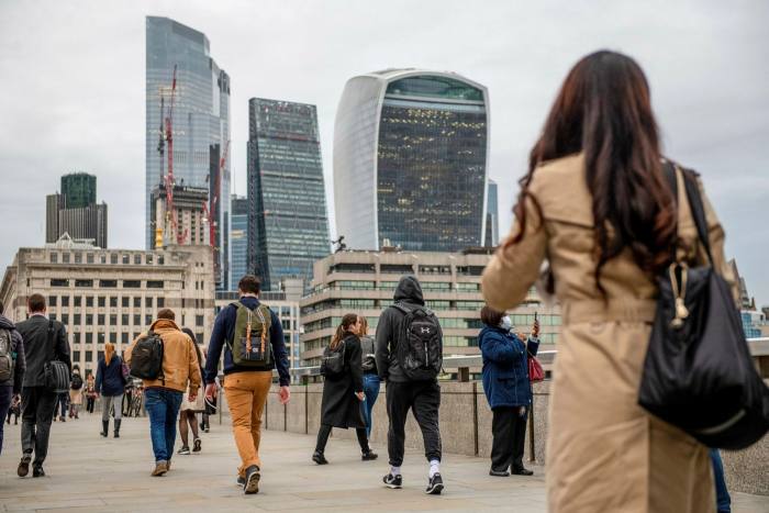 Commuters make their way over London Bridge towards the City of London on Thursday, September 30 2021