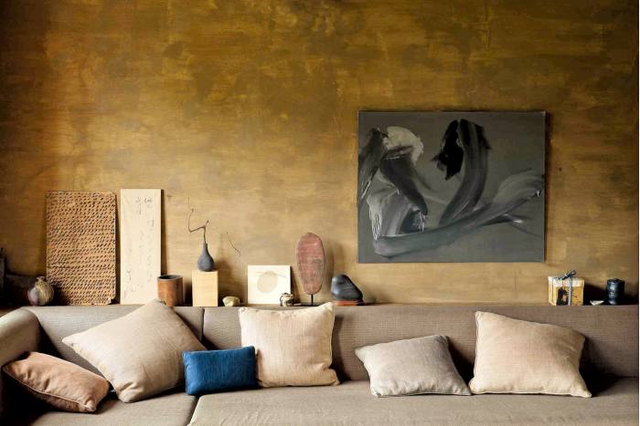The “Wabi” room at Axel Vervoordt’s home in Antwerp is painted in washed umber to offset the soft linen tones of the fabrics