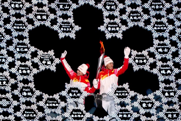 Dinigeer Yilamujiang, an ethnic Uyghur skier, and Zhao Jiawen at the opening ceremony