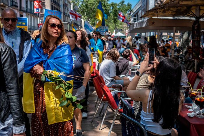 Ukrayna bayraklarına bürünmüş insanlarla Barselona'da bir sokak sahnesi