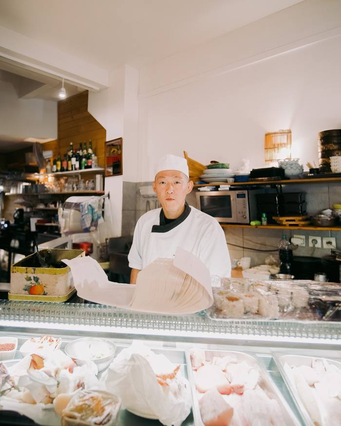 One of the chefs behind the counter at Sushi Marché