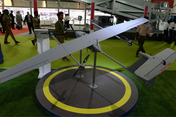 Indian visitors look at an unmanned aircraft of India’s Tata aerospace at the DefExpo 2018