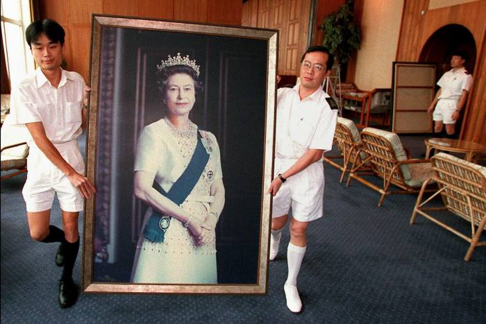 British sailors carry a portrait of Britain’s Queen Elizabeth II through the HMS Tamar, the British Forces’ Hong Kong headquarters, for the last time ahead of the end to British rule in Hong Kong in 1997