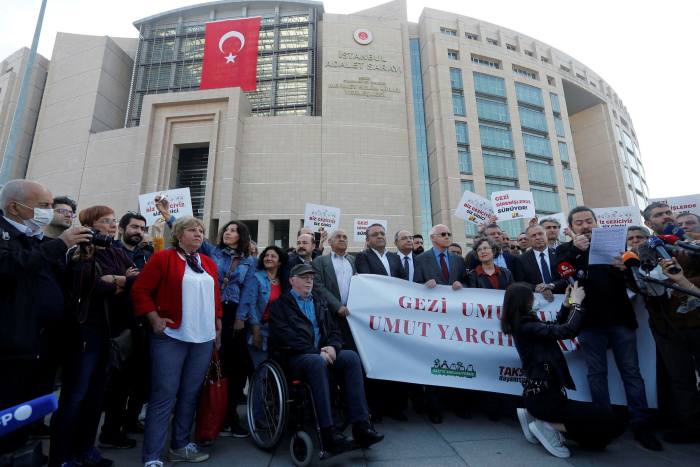 People gather as a Turkish court holds a hearing of Osman Kavala and 15 others over their role in nationwide protests in 2013