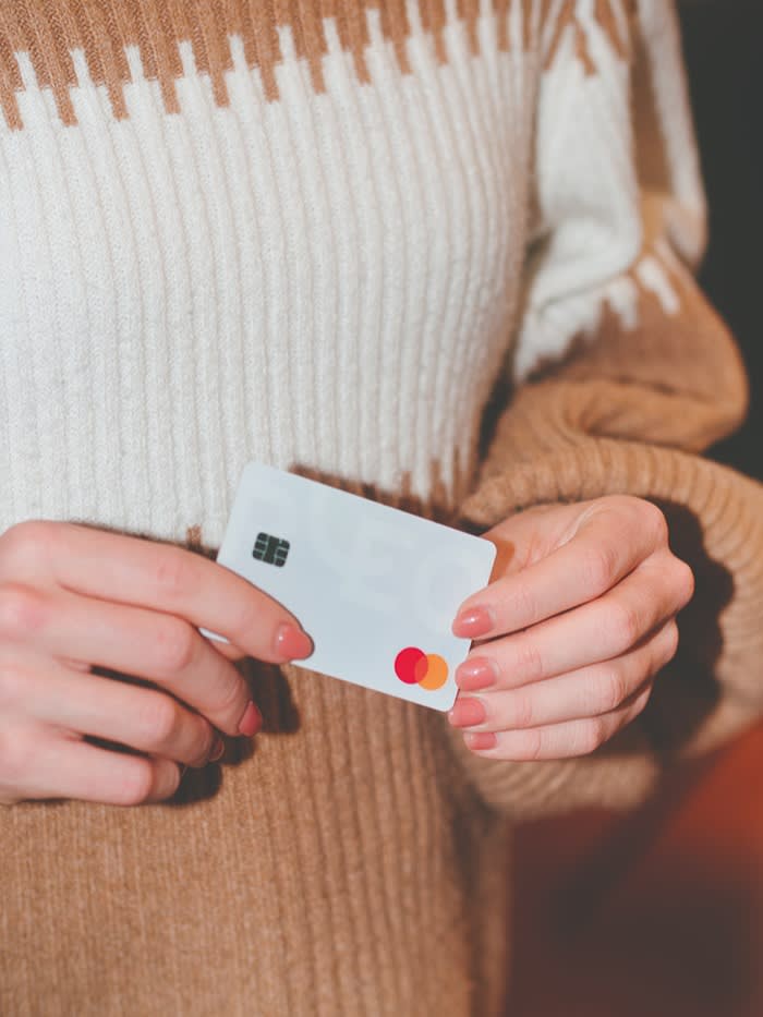 A woman holding a Pleo card