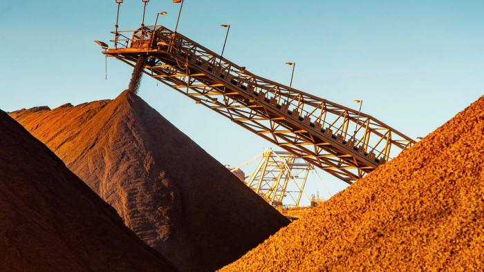 Iron ore falls from a conveyor to a stockpile at Port Hedland, Australia