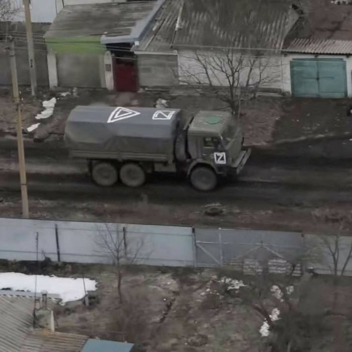 An aerial shot of a military truck with a triangle and a ‘Z’ painted on its roof