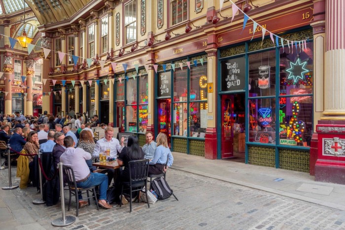 People outside a bar in the City of London's Leadenhall Market