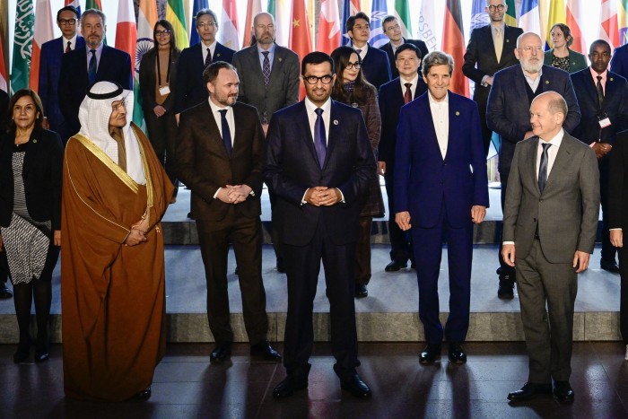 German Chancellor Olaf Scholz, right, glances at the Saudi energy minister Abdulaziz bin Salman, far left, as Denmark’s environment minister Dan Jorgensen, the UAE minister of industry and advanced technology and COP28 UAE president-designate Sultan al-Jaber and US climate envoy John Kerry look on during a group photo for the participants in the Petersberg Climate Dialogue meeting in Berlin in May