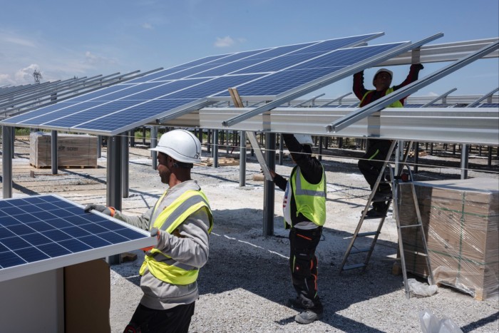 Workers install solar panels at a park near Avignon, south-east France