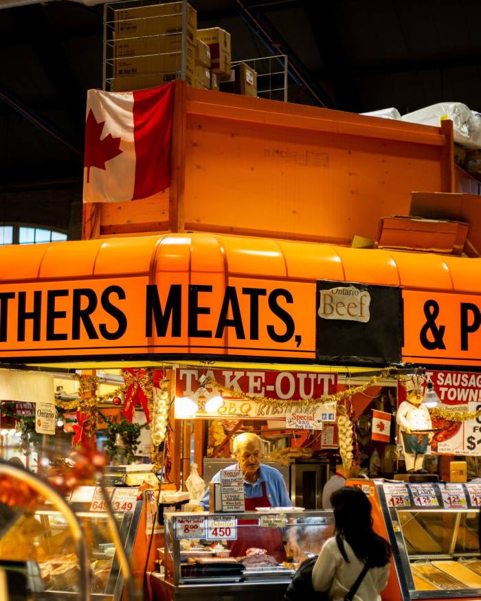 A customer at a butcher’s stall in St Lawrence Market