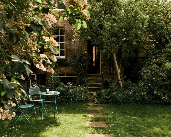 The back garden is home to a sculpture by Lucy Turner and a table by Trevor Dannatt