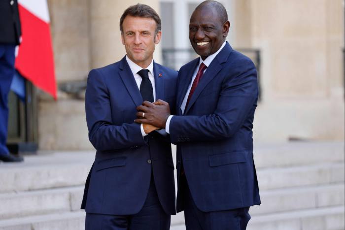 Emmanuel Macron greets William Ruto