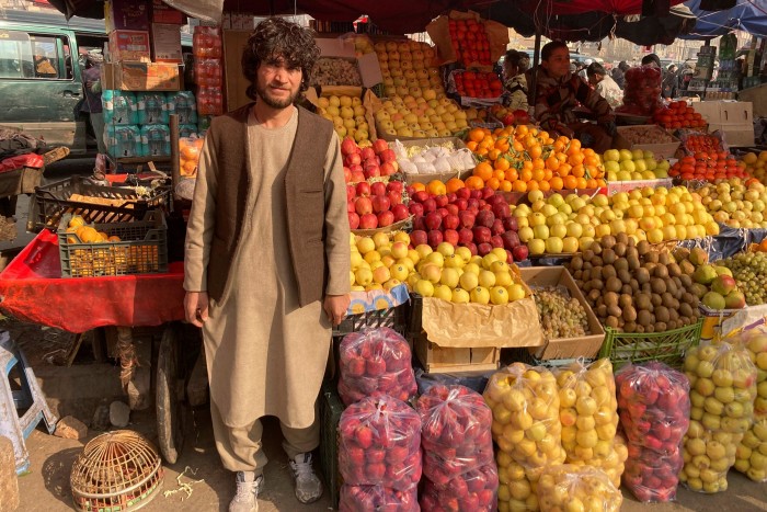 Mohammed Farid, a fruit seller in Kabul, with his stall