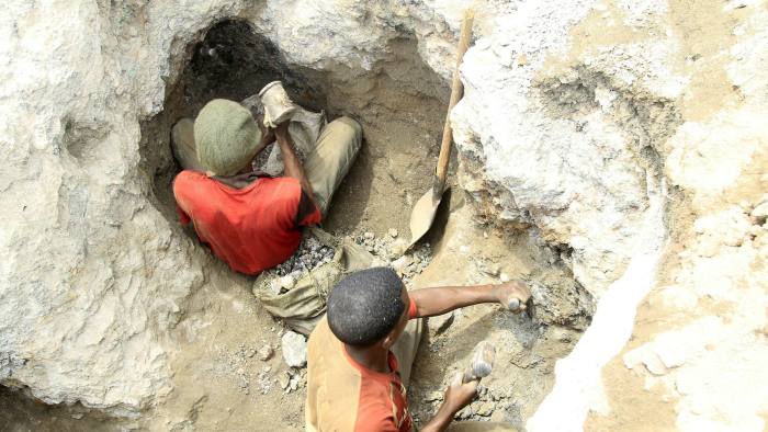 Miners work at a cobalt mine pit in  the Democratic Republic of Congo