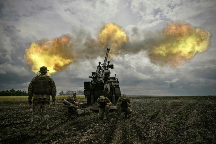 Ukrainian forces fire a French field gun towards Russian positions at a front line in the Donbas