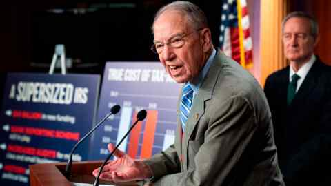 Chuck Grassley stabds at lectern during a news conference to oppose an increase of the IRS budget