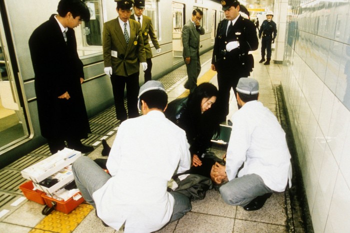 A commuter is helped by medics in a Tokyo metro station after the sarin gas attack in 1995