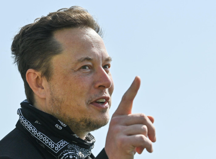 Elon Musk gestures as he visits the construction site of Tesla’s Gigafactory in Gruenheide near Berlin