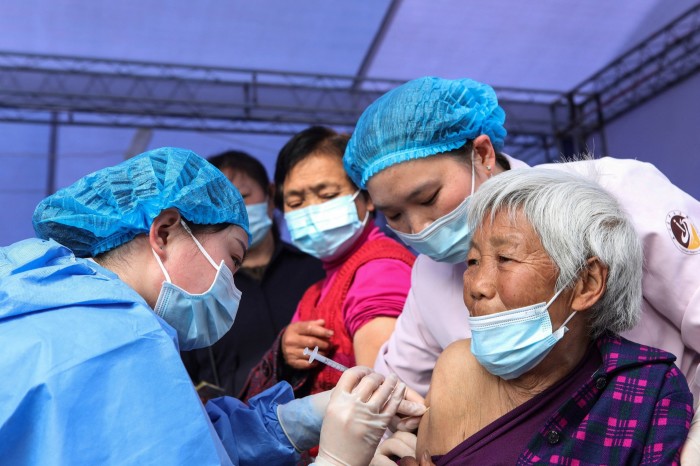 Chinese woman receiving covid vaccine