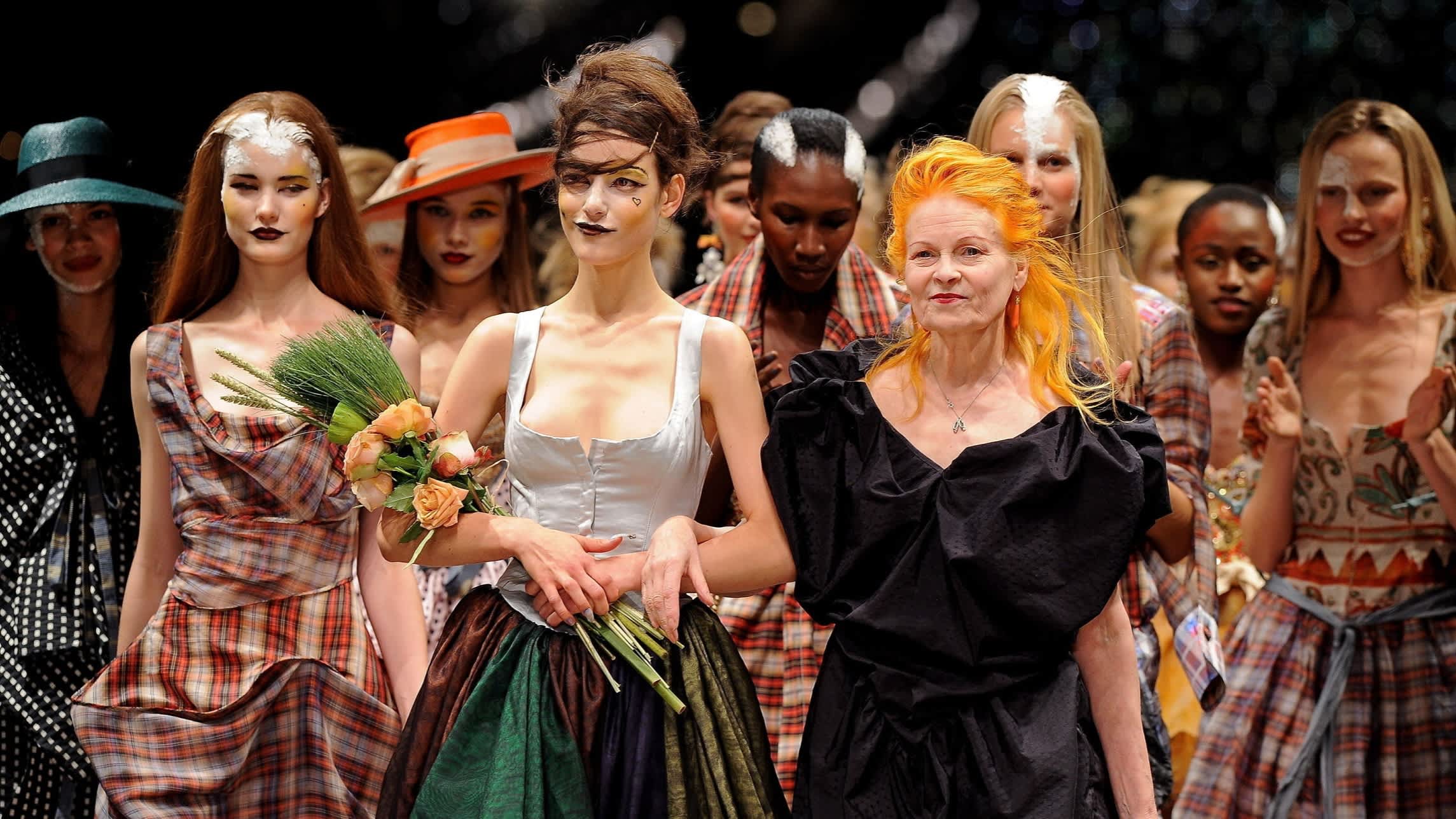 Vivienne Westwood poses with models on the runway