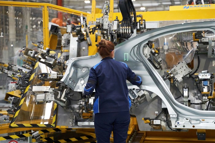 A BMW employee assembles components of Series 3 vehicle at the company’s Mexico facility in April. While BMW has launched two electric models, it is concerned that charging infrastructure will not be able to keep pace with the headlong rush into EVs
