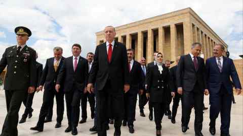 President Recep Tayyip Erdogan walks in Ankara with ministers.Turkey urgently needs to turn away from economically ignorant president's policies