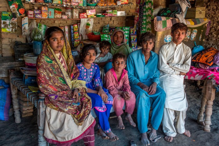 A family in their makeshift shop set up in Dadu, Sindh