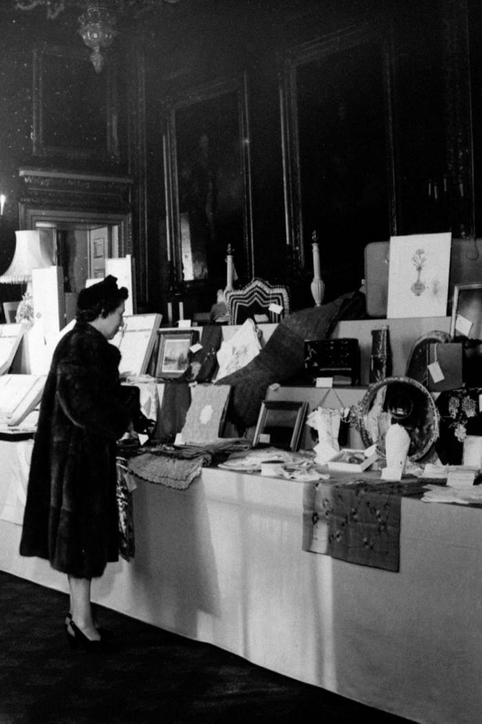 A woman views the wedding gifts on display at St James’s Palace