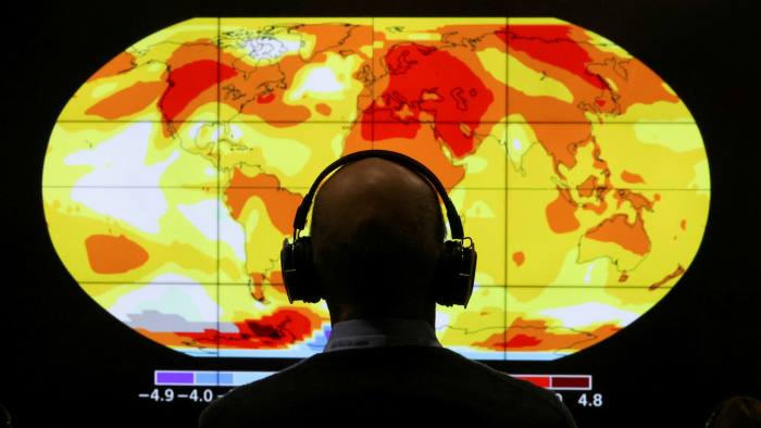 A delegate looks at a screen during the COP26 conference in Glasgow
