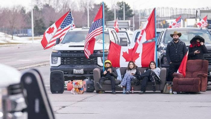 Anti-vaccine protesters block a roadway at the Ambassador Bridge, a critical crossing between the US and Canada