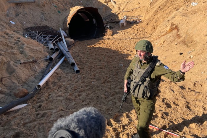 An Israeli soldier stands outside a section of tunnel built by Hamas under Gaza, on December 15 2023