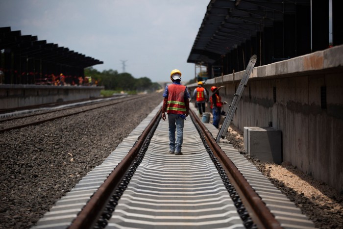 Workers walk at the construction of Uman Mayan Train station, in Uman, Yucatan state, Mexico