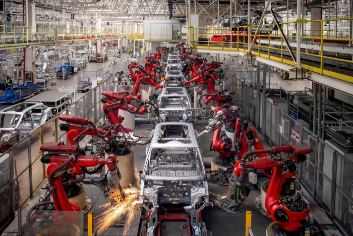 Robotic arms assemble cars at the Leapmotor electric vehicle factory in Jinhua, Zhejiang province