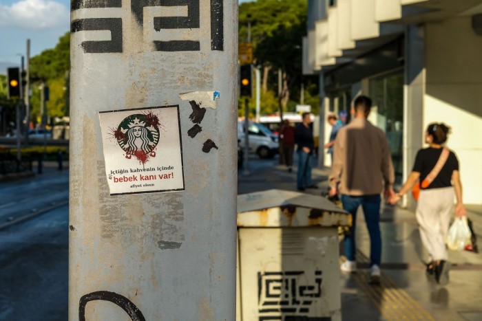 Stickers on a lamp post in Turkey against Starbucks