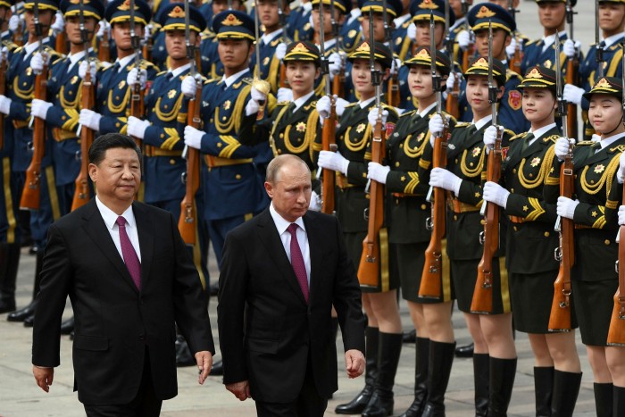 Vladimir Putin reviews a military honour guard with Chinese President Xi Jinping during a welcoming ceremony outside the Great Hall of the People in Beijing on June 8 2018