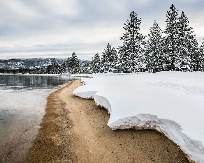Snow covers the beach at the Ski Run Marina in the Sierra Nevada mountains in 2017