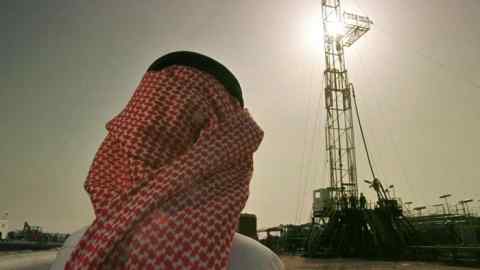 FILE - In this Feb. 26, 1997 file photo, Khaled al-Otaiby, an official of the Saudi oil company Aramco, watches progress at a rig at the al-Howta oil field near Howta, Saudi Arabia. According to an assessment published Monday, April 1, 2019, by Moody‚Äôs Investors Services, the net profits of Saudi Aramco reached $111 billion last year. That places Aramco ahead of some of the world‚Äôs most profitable firms. In their first-ever grade assessment for Aramco, Fitch Ratings issued the firm an A+ rating, while Moody‚Äôs gave it it‚Äôs A1 rating ahead of its upcoming bonds sale. (AP Photo/John Moore, File)