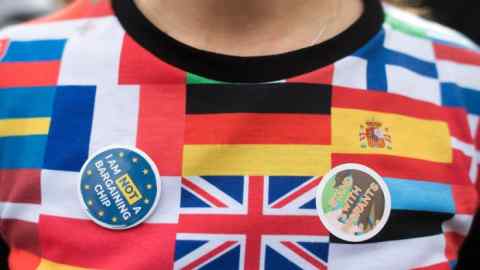 A woman wears a top showing flags of European Union countries during a &quot;Flag Mob&quot; demonstration in Parliament Square in central London on February 20, 2017, part of a national day of action in support of migrants in the UK. 
Under the banner One Day Without Us men, women and children come together for a day of action to stress that they want Britain to remain open and welcoming. A number of businesses closed for the day to make the point that the Britain couldnt manage for even one day without the contribution of migrants. 
 / AFP PHOTO / Justin TALLIS        (Photo credit should read JUSTIN TALLIS/AFP/Getty Images)