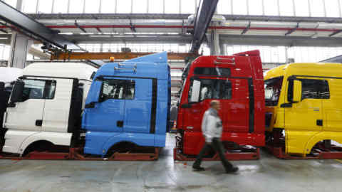 A man walks past driver cabins in the truck production plant of German truck and bus-maker MAN AG in Munich, Germany July 30, 2015. REUTERS/Michaela Rehle - RTX1MEUS